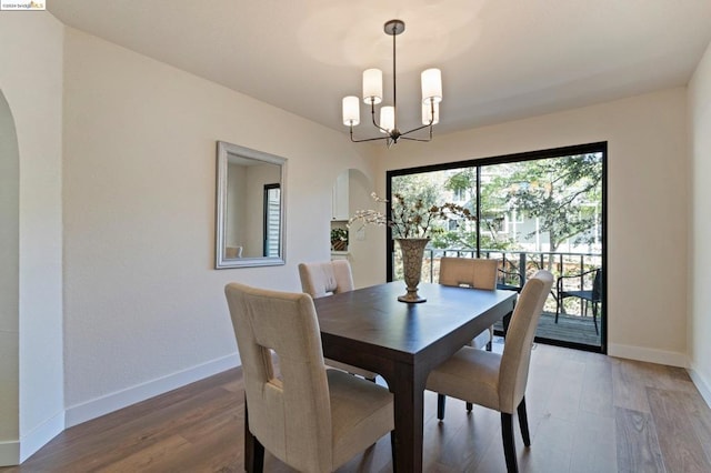 dining space with a chandelier and hardwood / wood-style floors