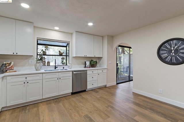 kitchen featuring dishwasher, white cabinetry, and a wealth of natural light