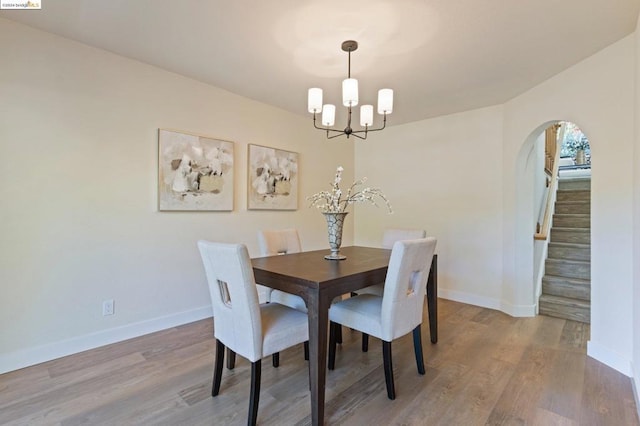 dining area featuring a notable chandelier and light hardwood / wood-style floors