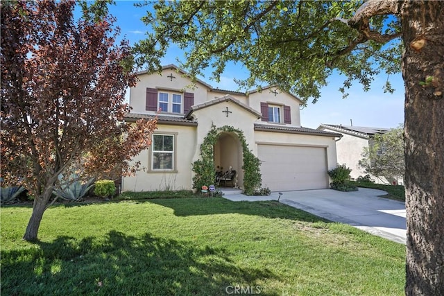 mediterranean / spanish-style house with a front yard and a garage