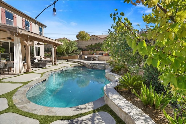 view of swimming pool featuring ceiling fan and a patio