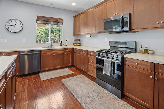 kitchen with dark hardwood / wood-style flooring, sink, and stainless steel appliances