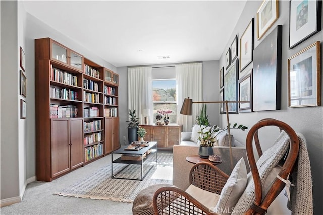 sitting room featuring light colored carpet