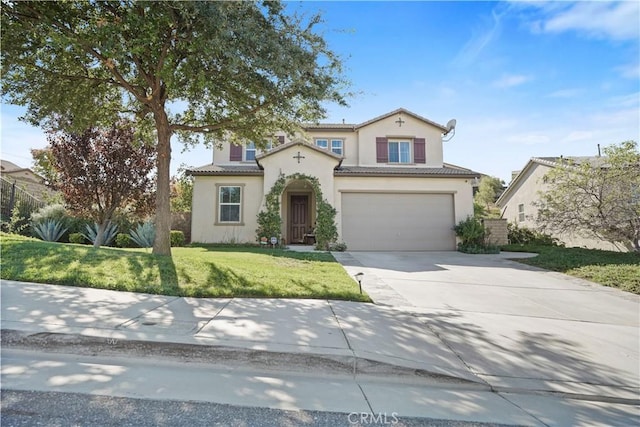 mediterranean / spanish-style home with a garage and a front lawn