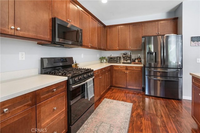 kitchen featuring dark hardwood / wood-style flooring and stainless steel appliances