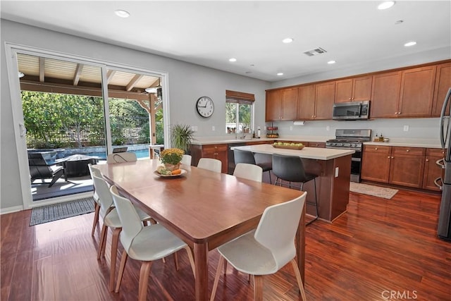 dining room featuring sink and dark hardwood / wood-style floors