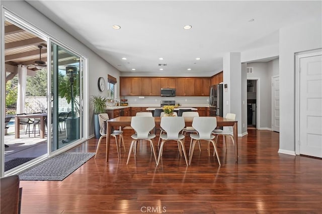 kitchen with a kitchen island, dark wood-type flooring, and appliances with stainless steel finishes