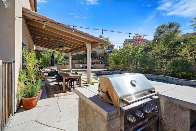 view of patio / terrace with an outdoor kitchen, area for grilling, and ceiling fan