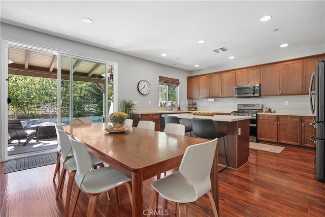 dining area with dark hardwood / wood-style flooring