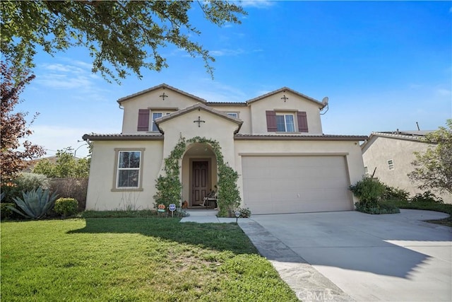 mediterranean / spanish house with a front yard and a garage