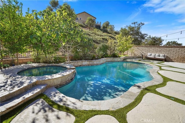 view of pool with an in ground hot tub