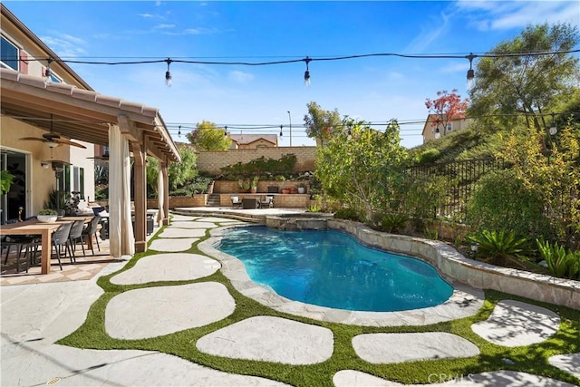 view of swimming pool with ceiling fan and a patio area