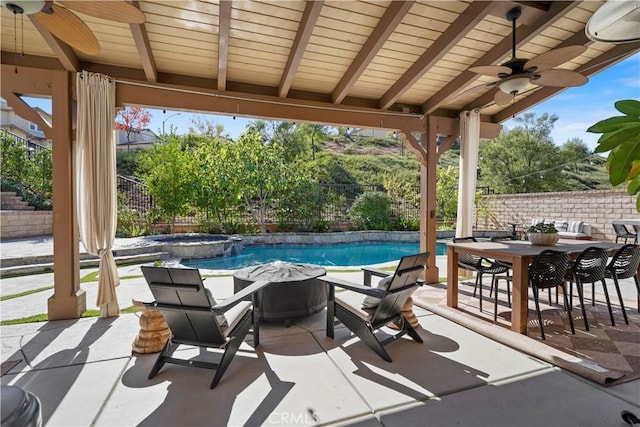 view of patio with a fenced in pool and ceiling fan