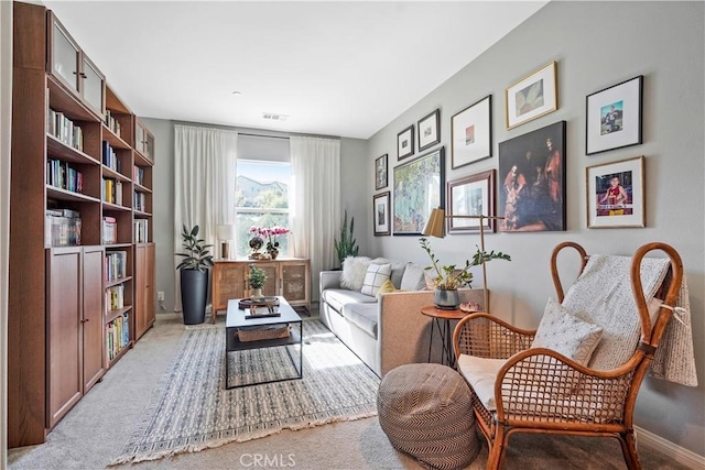 sitting room featuring light carpet