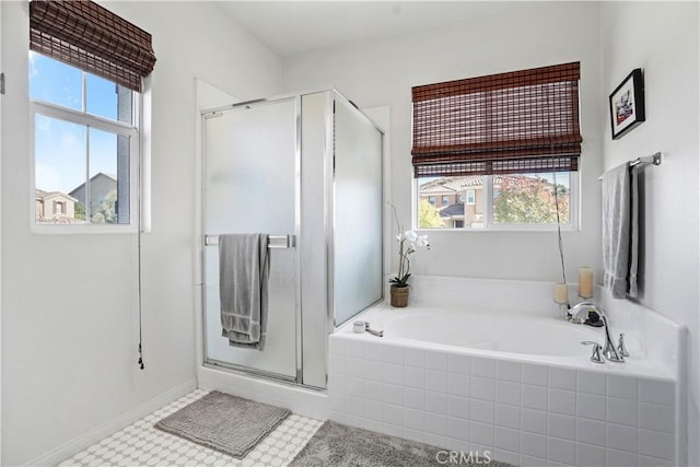 bathroom featuring plenty of natural light and independent shower and bath