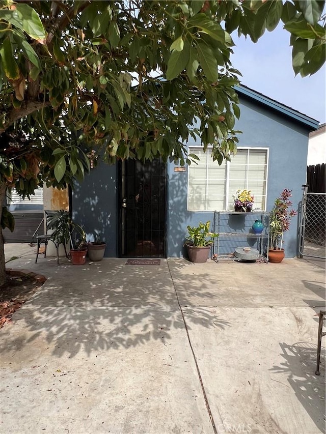 view of side of property with a patio area