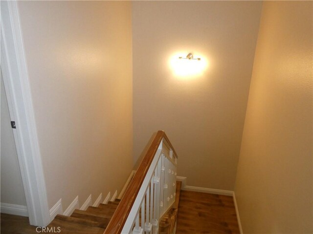 stairs with hardwood / wood-style flooring