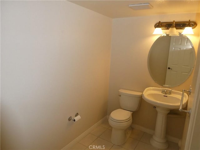 bathroom with tile patterned floors, toilet, and sink