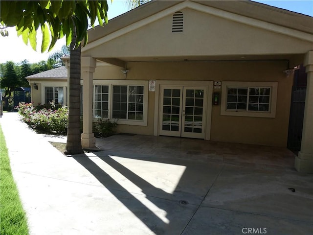 rear view of property featuring french doors and a patio area