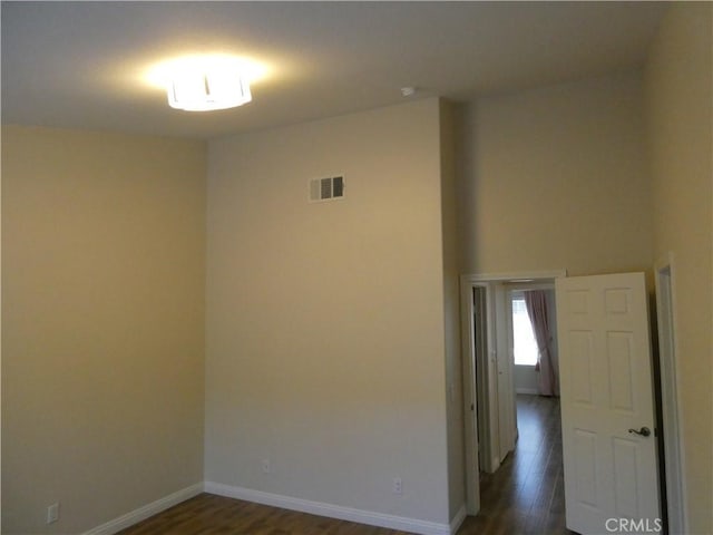 spare room with dark wood-type flooring