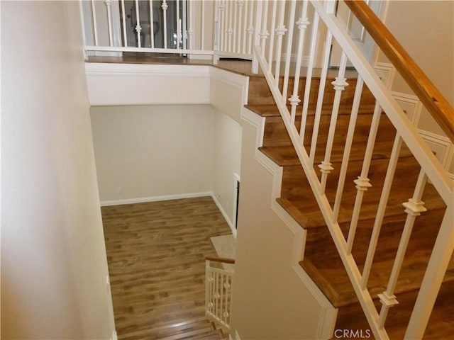 stairs with wood-type flooring