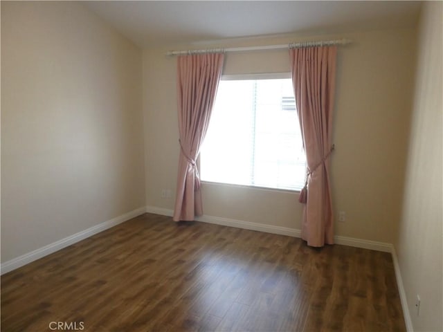 unfurnished room featuring dark wood-type flooring