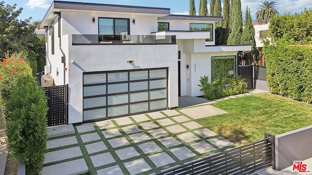 contemporary house featuring a garage and a front yard