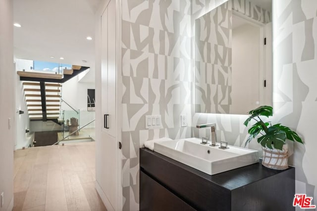 bathroom featuring hardwood / wood-style floors and vanity