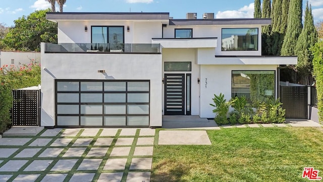 contemporary home with a garage and a front yard