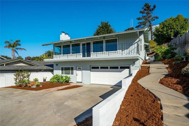 front facade with a garage and a balcony