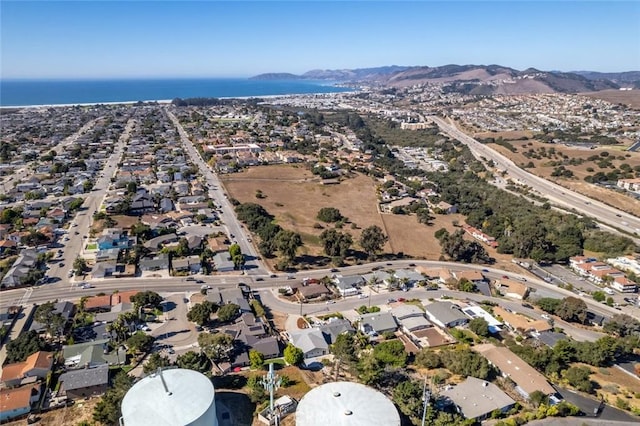 drone / aerial view with a water and mountain view