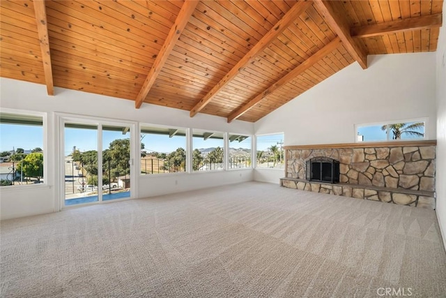 unfurnished living room with carpet, high vaulted ceiling, a stone fireplace, and wooden ceiling