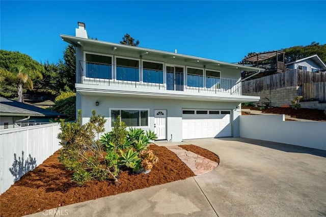 view of front facade with a balcony and a garage