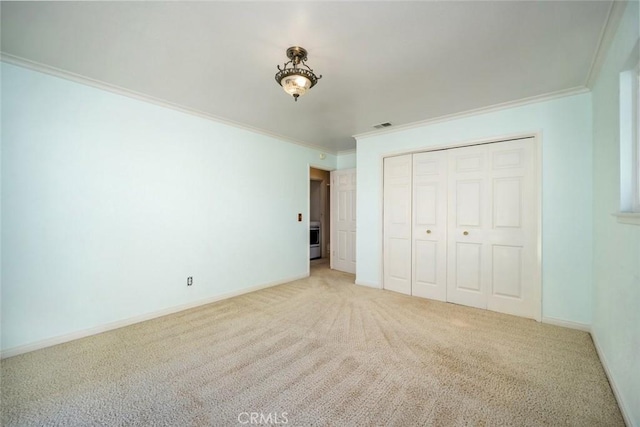 unfurnished bedroom with light carpet, a closet, and ornamental molding