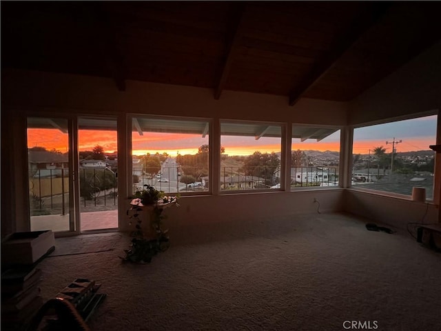 unfurnished sunroom with beam ceiling