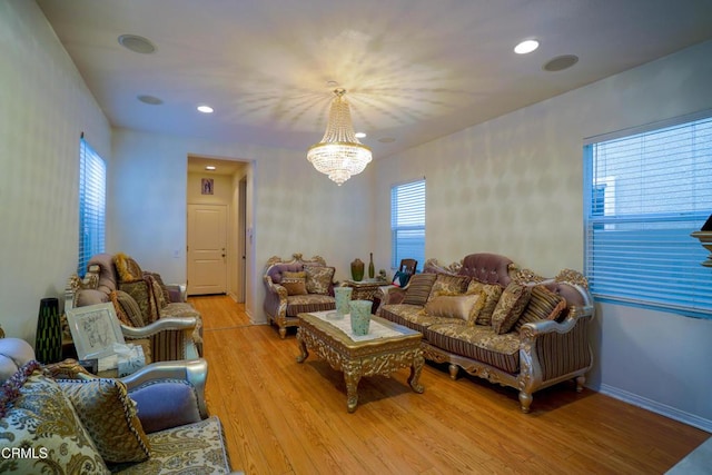 living room with a notable chandelier and wood-type flooring