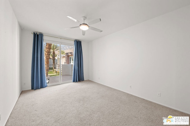 carpeted spare room with ceiling fan