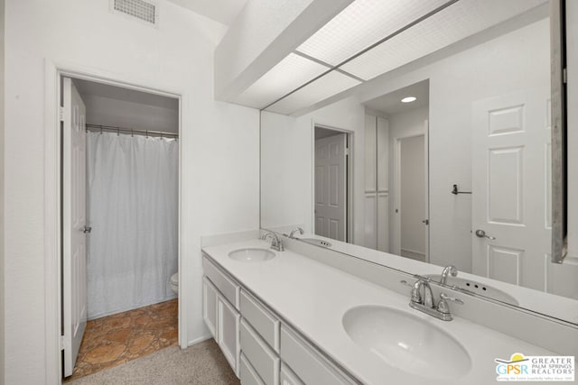 bathroom featuring toilet and vanity