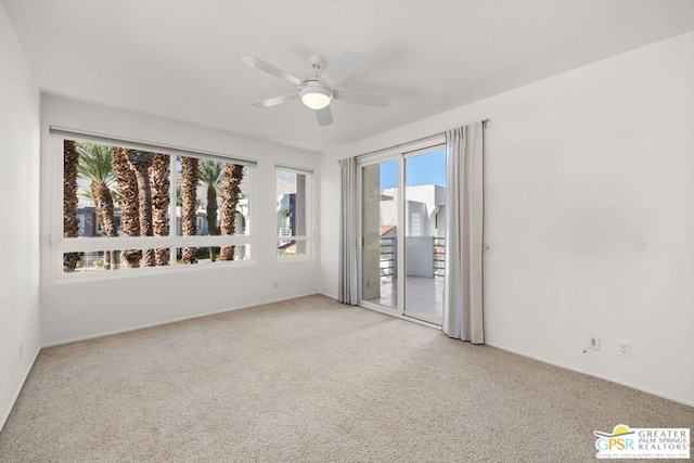 carpeted spare room featuring ceiling fan