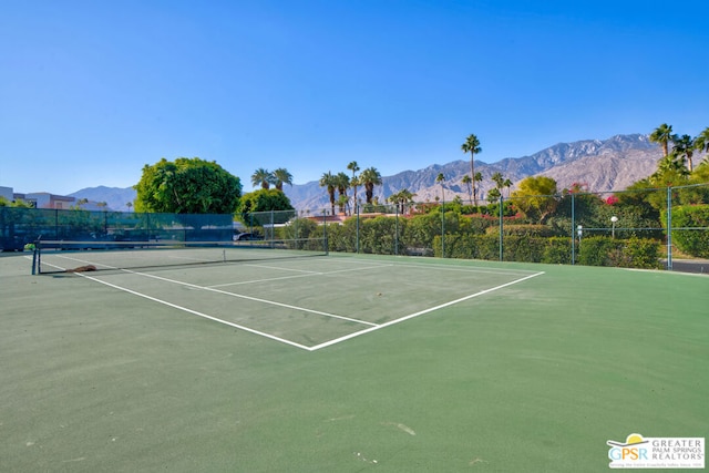 view of tennis court with a mountain view