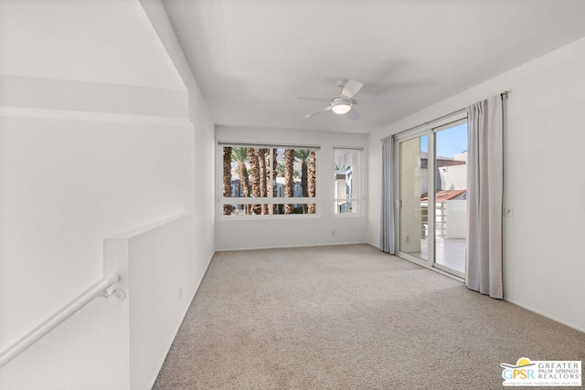 spare room featuring ceiling fan, light carpet, and plenty of natural light