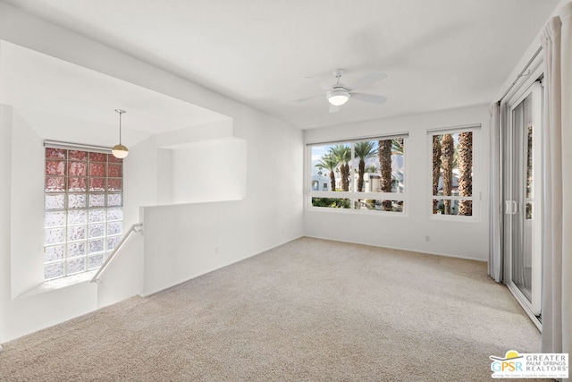 carpeted spare room with ceiling fan