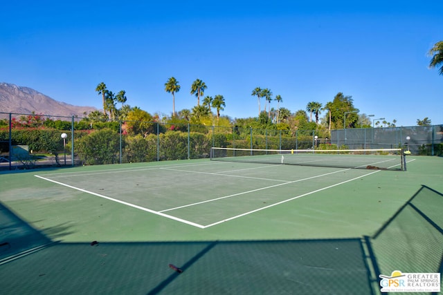 view of tennis court with a mountain view