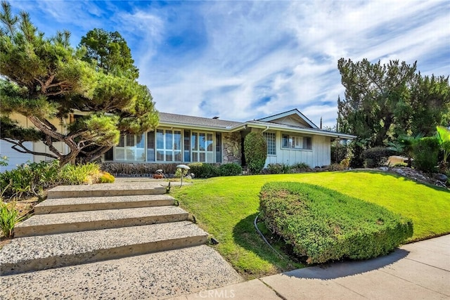 4614 La Subida Pl, Tarzana, CA 91356 - ranch-style home with stone siding, a front lawn, and board and batten siding