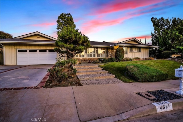 4614 La Subida Pl, Tarzana, CA 91356 - ranch-style home with board and batten siding, a garage, driveway, a front yard, and a porch