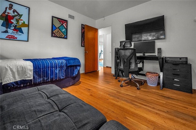 bedroom with hardwood / wood-style floors