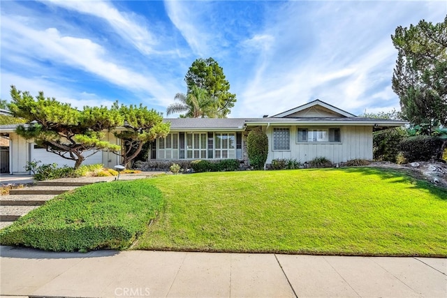 ranch-style home with a garage and a front lawn