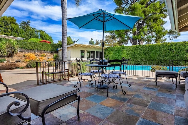 view of patio with a fenced in pool