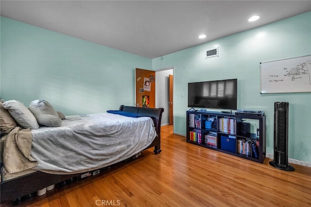 bedroom with hardwood / wood-style floors