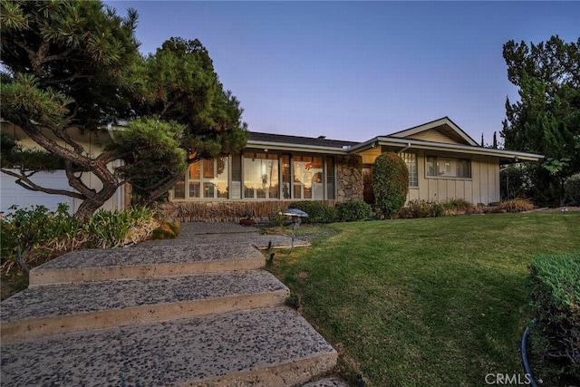 4614 La Subida Pl, Tarzana, CA 91356 - view of front of property featuring board and batten siding, a yard, and stone siding